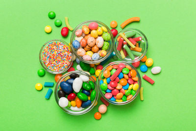 Directly above shot of multi colored candies on yellow background
