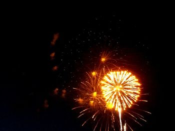 Low angle view of firework display at night