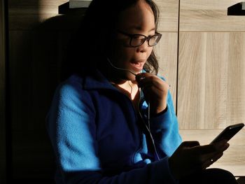 Woman using mobile phone at home