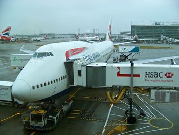 High angle view of airplane on airport runway against sky