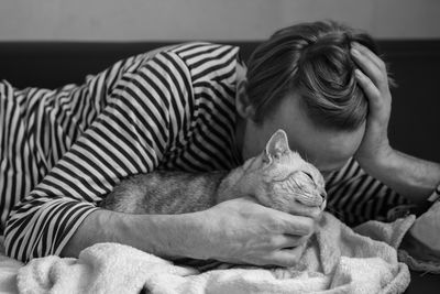 Cat sleeping on bed at home