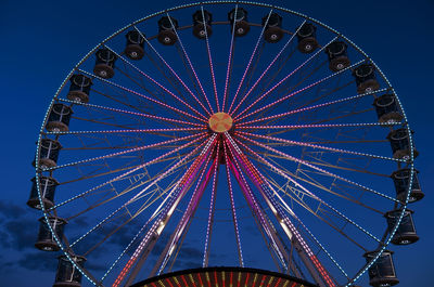 Low angle view of ferris wheel against sky