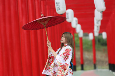 Woman holding red umbrella