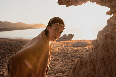 Portrait of young woman looking at beach