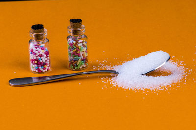 Close-up of cake on table against orange background