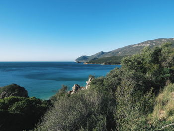 Scenic view of sea against clear blue sky