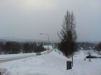 Snow covered landscape against sky