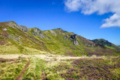 Scenic view of mountains against blue sky