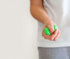 Midsection of woman squeezing stress ball 