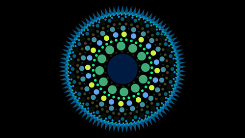 Close-up of illuminated electric lamp against black background