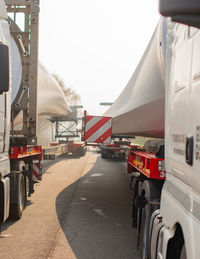 Vehicles on road in city against sky