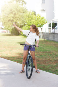 Full length rear view of woman riding bicycle