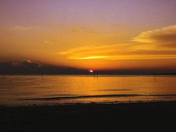 Scenic view of sea against romantic sky at sunset