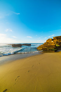 Scenic view of sea against blue sky