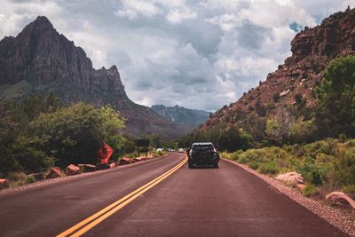 Road amidst mountains against sky