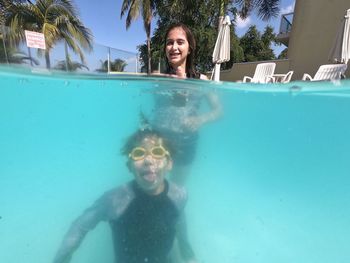 Portrait of siblings swimming in pool