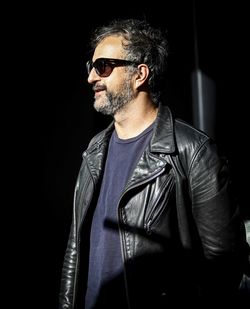 Man wearing sunglasses against black background