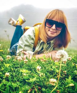 Woman with flowers on field