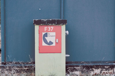 Close-up of military telefon information sign on wall