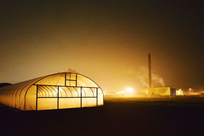 Illuminated built structure against clear sky at night