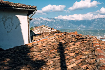 Shadow of building on mountain against sky