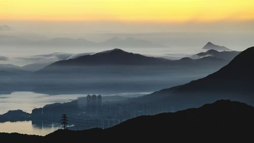 Scenic view of mountains against sky at sunset