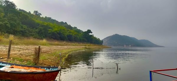 Scenic view of lake and mountains against sky