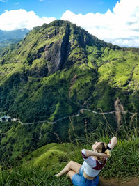 Midsection of person on mountain against clear sky