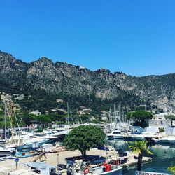 High angle view of boats moored at harbor against mountains