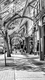 People walking in corridor of building