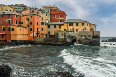 Waves crashing on the small beach of the old fishing village, boccadasse, genoa, liguria, italy