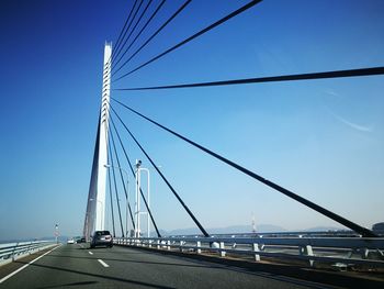 Low angle view of suspension bridge against sky