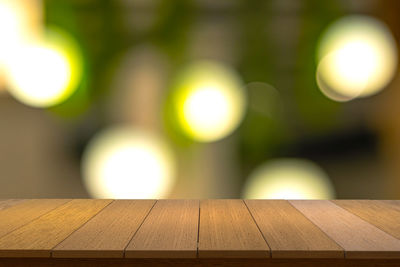 Close-up of illuminated light bulb on table