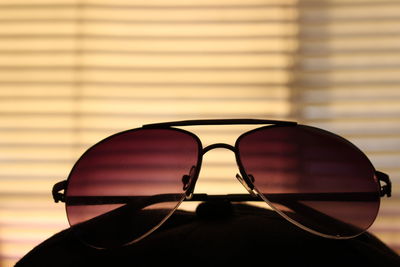 Close-up of sunglasses against window