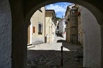 A narrow street between the old houses of sasso di castalda, a village of basilicata region, italy.