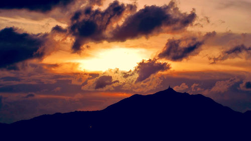 Scenic view of mountains against cloudy sky