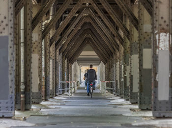 Rear view of people walking in building