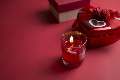 Close-up of lit candle on table