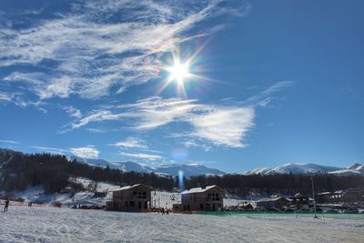 Scenic view of snowcapped mountains against sky on sunny day