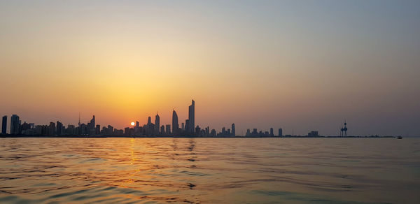View of buildings in city during sunset