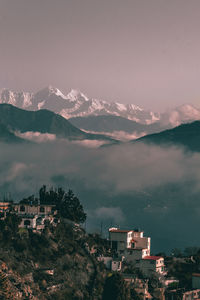 High angle view of townscape by mountain against sky