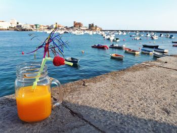 High angle view of drink by sea against sky