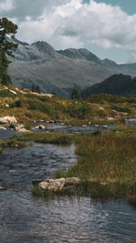 Scenic view of lake and mountains against sky