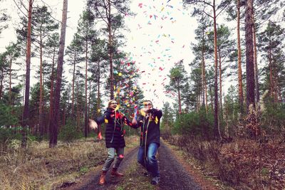 People walking on footpath in forest