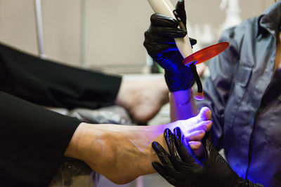 Low section of man holding hands