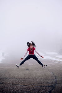 Portrait of young woman in foggy weather