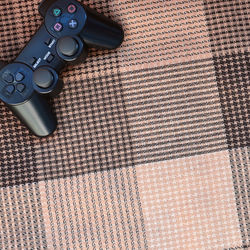 High angle view of game controller on textile