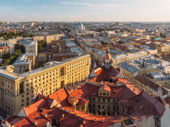 Aerial view on gothic building with red roof and trinity cathedral in saint petersburg.