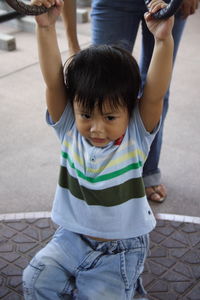 Low section of boy playing with father