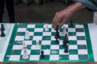 High angle view of man playing on chess board